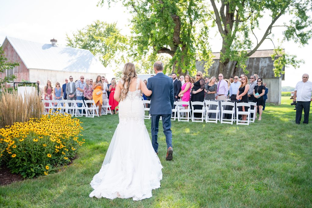 bride and her father walk down the aisle at The Lincoln Farmstead