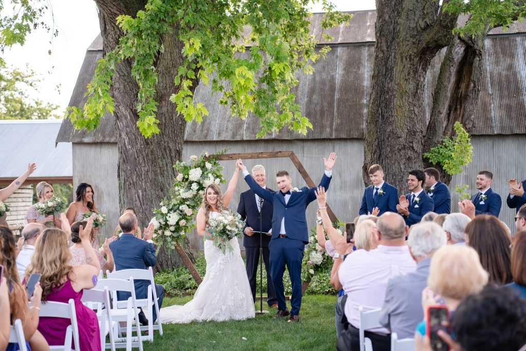 bride and groom celebrate after wedding ceremony The Lincoln Farmstead