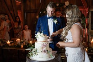 bride and groom cut cake wedding reception The Lincoln Farmstead